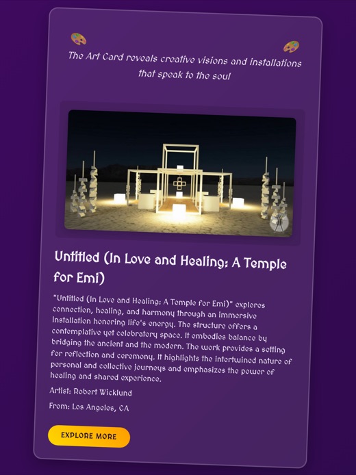 A purple tarot-style card reading 'The Art Card reveals creative visions and installations that speak to the soul', above a night photograph of a lit timber temple standing on the open playa. Below it the title Untitled (In Love and Healing: A Temple for Emi), a short description, the artist Robert Wicklund of Los Angeles, and an Explore More button.